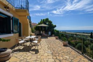 a patio with a table and chairs and the ocean at Casa di Pupa in Minia