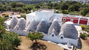 an aerial view of a building with pointed roofs at Masseria Trulli sull'Aia in Cisternino