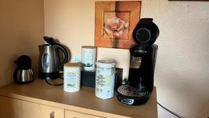 a counter with a coffee maker and cups on it at Apartment centrally located in the Rhine-Main area in Riedstadt