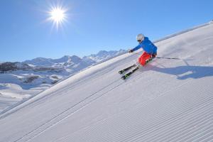 a person is skiing down a snow covered slope at Appartements Aurikel Corso in Ischgl