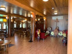 - un hall avec une salle dotée de tables et d'une guitare dans l'établissement MonMin Farmstay, à Ban Mae Cho