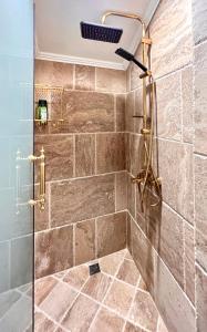 a bathroom with a shower with a glass door at Апартаменти Стефани in Plovdiv +55 photos