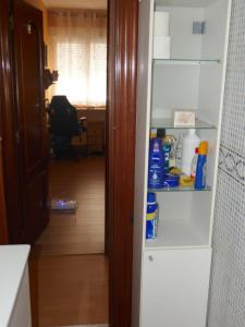 an open door to a kitchen with a refrigerator at Habitaciones en Aviles in Avilés