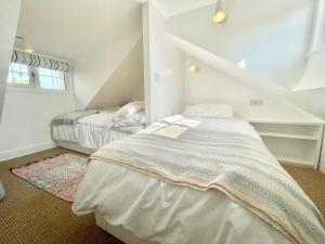 a bedroom with two beds in a attic at Normanby Cottage Runswick Bay in Runswick