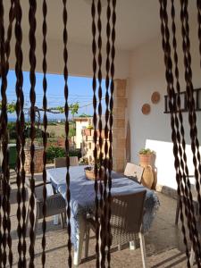 a dining room with a table and a view of the ocean at Casa Alba in Marina di Pescoluse