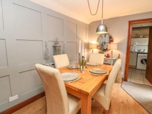 a dining room with a wooden table and chairs at Dere Cottage in Richmond