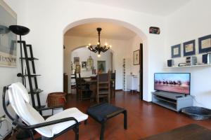 a living room with a television and a dining room at Villa Cremona in Forte dei Marmi