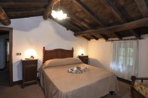 a bedroom with a bed with a plate of food on it at Il Vecchio Mulino in Coreglia Antelminelli