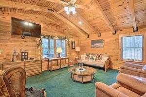 a living room filled with furniture and a flat screen tv at Charming Austin Cabin on 96 Acres of Land! 