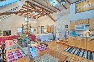 ein Wohnzimmer mit einem roten Sofa und einer Küche in der Unterkunft Pet-Friendly Loft Vacation Rental with Fire Pit! in Bemus Point