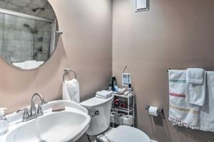 a bathroom with a sink and a toilet and a mirror at Countryside Vacation Rental Retreat in Paola
