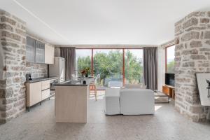 a kitchen with white appliances and a brick wall at Kampus Luxury Villas in Tríkala
