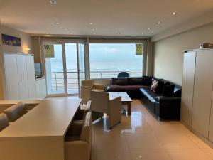 a living room with a couch and a table at "Puerto Cristo" - Great 2 Bedroom Appartment with Seaview D2 in Ostend