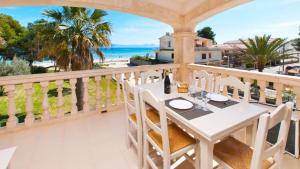 a white table on a balcony with a view of the ocean at SUN OF THE BAY in Alcudia