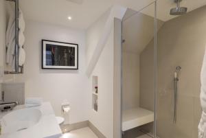 a white bathroom with a shower and a sink at Old Bank Hotel in Oxford +56 photos