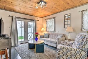 a living room with a couch and a table at Bemus Point Vintage Suite with Soaking Tub and Kitchen in Bemus Point