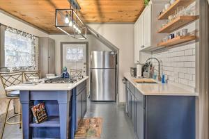 a kitchen with a stainless steel refrigerator and counters at Bemus Point Vintage Suite with Soaking Tub and Kitchen in Bemus Point