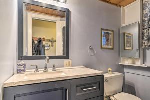a bathroom with a sink and a toilet and a mirror at Bemus Point Vintage Suite with Soaking Tub and Kitchen in Bemus Point +16 photos