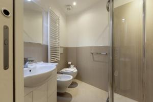 a bathroom with a sink and a toilet and a shower at Top Accommodations in the Heart of Milano! in Milan +20 photos