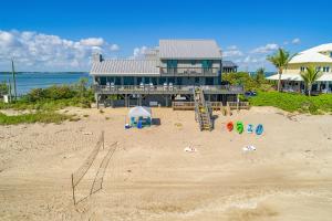 a house on a beach with a playground in the sand at Restoration Sands in Stuart