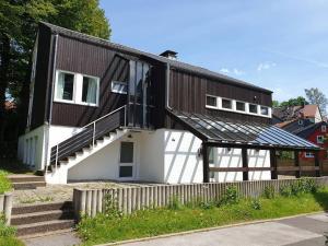 a house with a gambrel roof with a staircase at 16 Personen Harzhaus für Gruppen in Clausthal-Zellerfeld in Clausthal-Zellerfeld