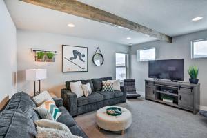 a living room with a couch and a tv at Mountain-View Granby Retreat on Golf Course! in Granby