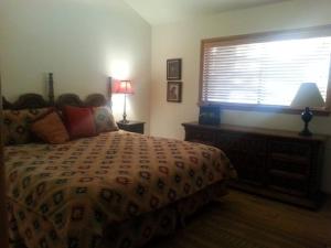 a bedroom with a large bed and a window at Cozy Flagstaff Home in Cool Pines - Country Club in Flagstaff