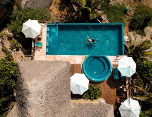 an overhead view of a person swimming in a swimming pool at Hotel El Copal in Mazunte