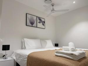 a white bedroom with a bed with towels on it at CBD RiverView 2Bed Apt Kingbed at Tallest building in Brisbane +22 photos
