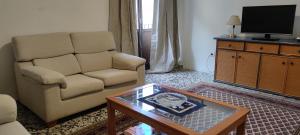 a living room with a couch and a coffee table at Ca Sanchis, piso en el casco antiguo in Xàtiva
