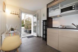 a kitchen with a sink and a counter at Hotel Residence Alaïa in Ascain