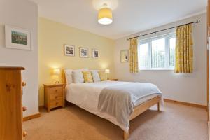 a bedroom with a bed and a window at Yewdale Cottage Coniston in Coniston
