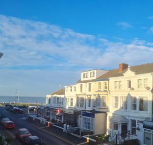 a row of buildings on a street next to the ocean at Beverley Dean - Children Over 5 Years Welcome - Continental Breakfast in Blackpool