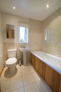 a bathroom with a toilet and a tub and a sink at Yewdale Cottage Coniston in Coniston +13 photos
