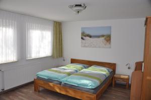 a bed sitting in a room with at Seevilla Wietjes Whg 1 in Baltrum