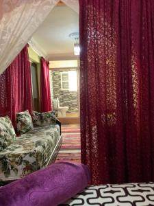 a living room with red curtains and a couch at House Naïma in Rabat