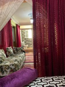 a living room with red curtains and a couch at House Naïma in Rabat