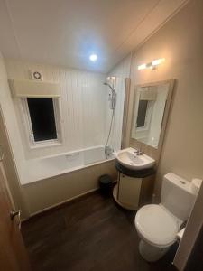 a bathroom with a toilet and a sink at Beautiful 2-Bedroom Lodge with Spectacular Views in Hartlepool