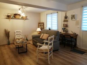 a living room with a couch and a table at Le passeur de Rêves in Quend