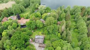 an aerial view of a house in the middle of a forest at Ferienwohnung An der Farchauer Mühle in Schmilau +15 photos