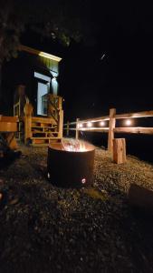 a fire pit in front of a house at night at The Lodge on Harrison Lake in Harrison Hot Springs