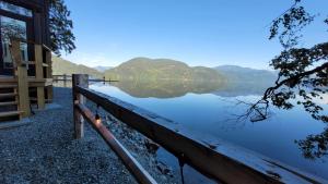 a view of a lake with mountains in the background at The Lodge on Harrison Lake in Harrison Hot Springs