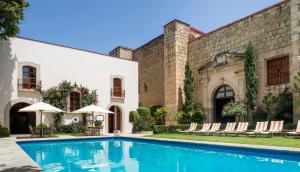 a swimming pool in front of a building at Quinta Real Oaxaca in Oaxaca City