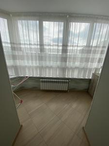 an empty room with a window and a radiator at Apartament Vasilya Porika 48 Street Vinnitsya in Vinnytsya