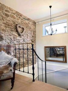 a room with a stone wall with a heart on the wall at Secluded Escape near Salcombe - Newhouse Barn. in Malborough