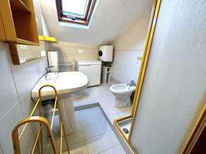a small bathroom with a sink and a toilet at Suite a 1 minuto dalla spiaggia a piedi - Sanremo in Sanremo