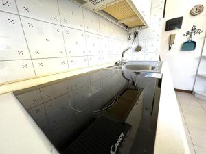 a small kitchen with a sink and a sink at Suite a 1 minuto dalla spiaggia a piedi - Sanremo in Sanremo