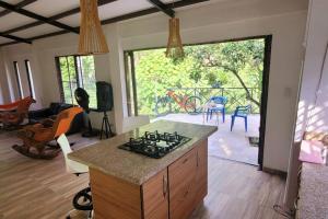 a kitchen with a stove top oven in a room at Acogedora casa campestre, con parqueadero privado in Nimaima