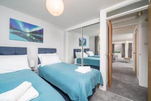 1 Schlafzimmer mit 2 Betten und einem Spiegel in der Unterkunft Spacious Pet-Friendly Apartment in Crawley by Sublime Stays in Three Bridges