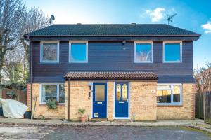 a brick house with a blue door at Spacious Pet-Friendly Apartment in Crawley by Sublime Stays in Three Bridges